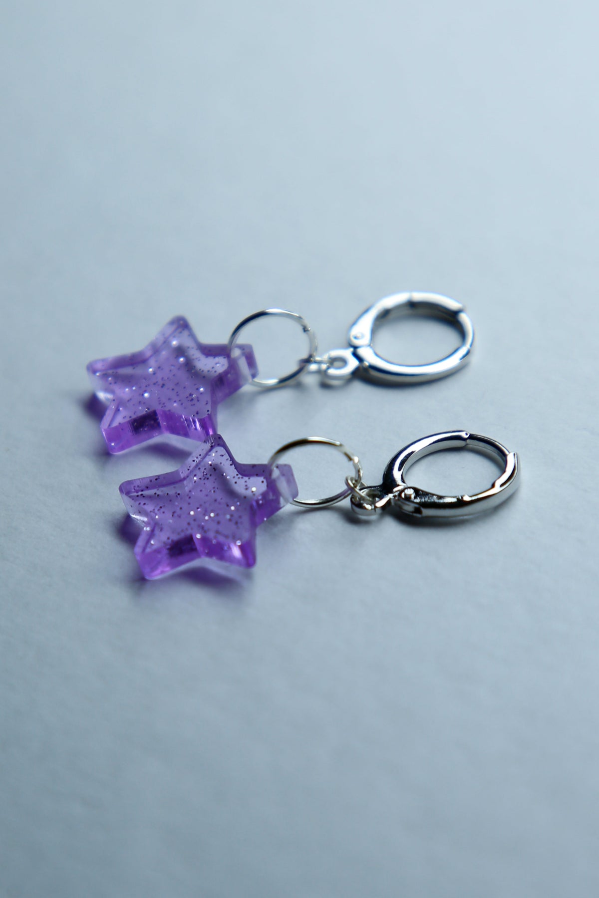 two purple star glitter acrylic earrings