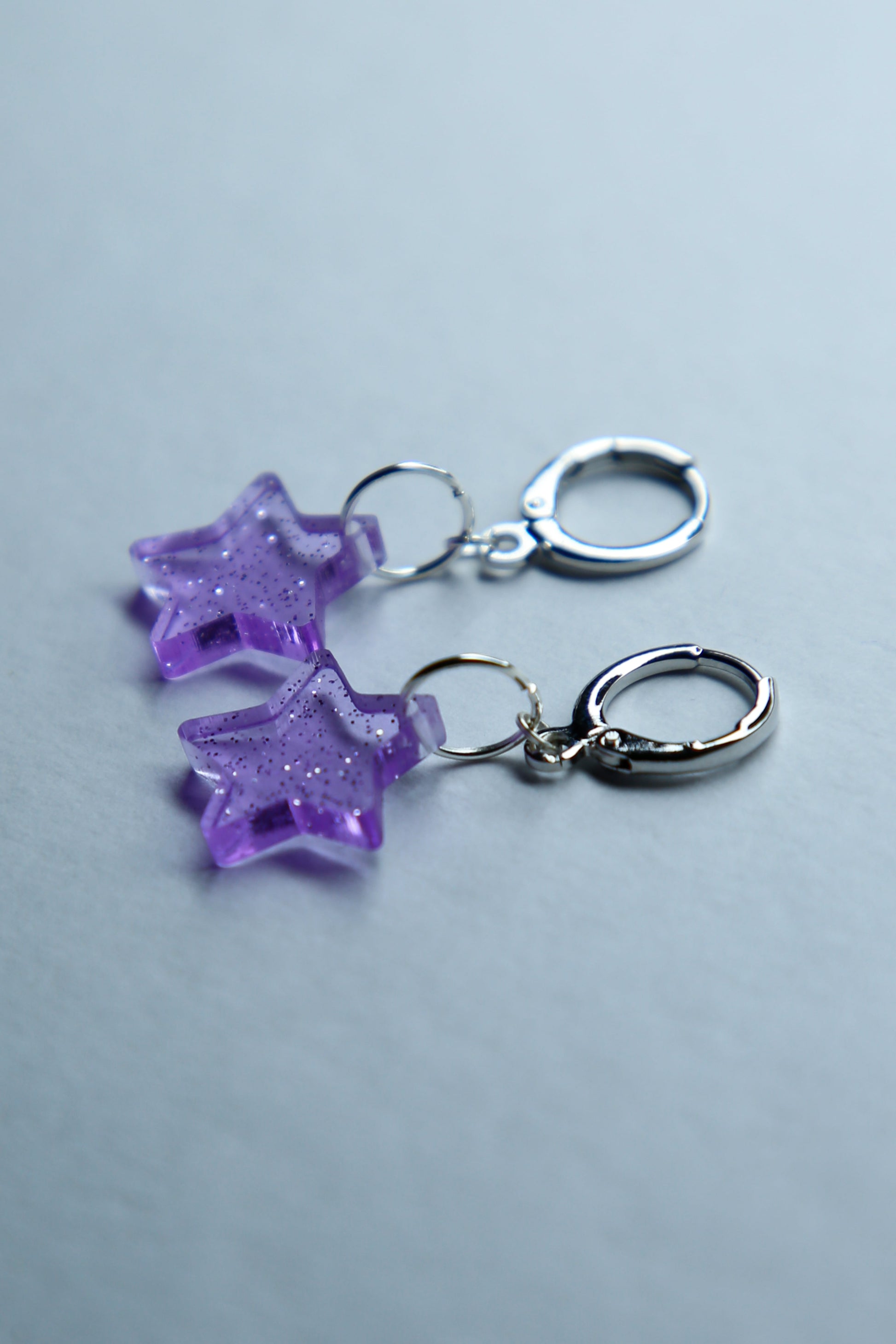 two purple star glitter acrylic earrings