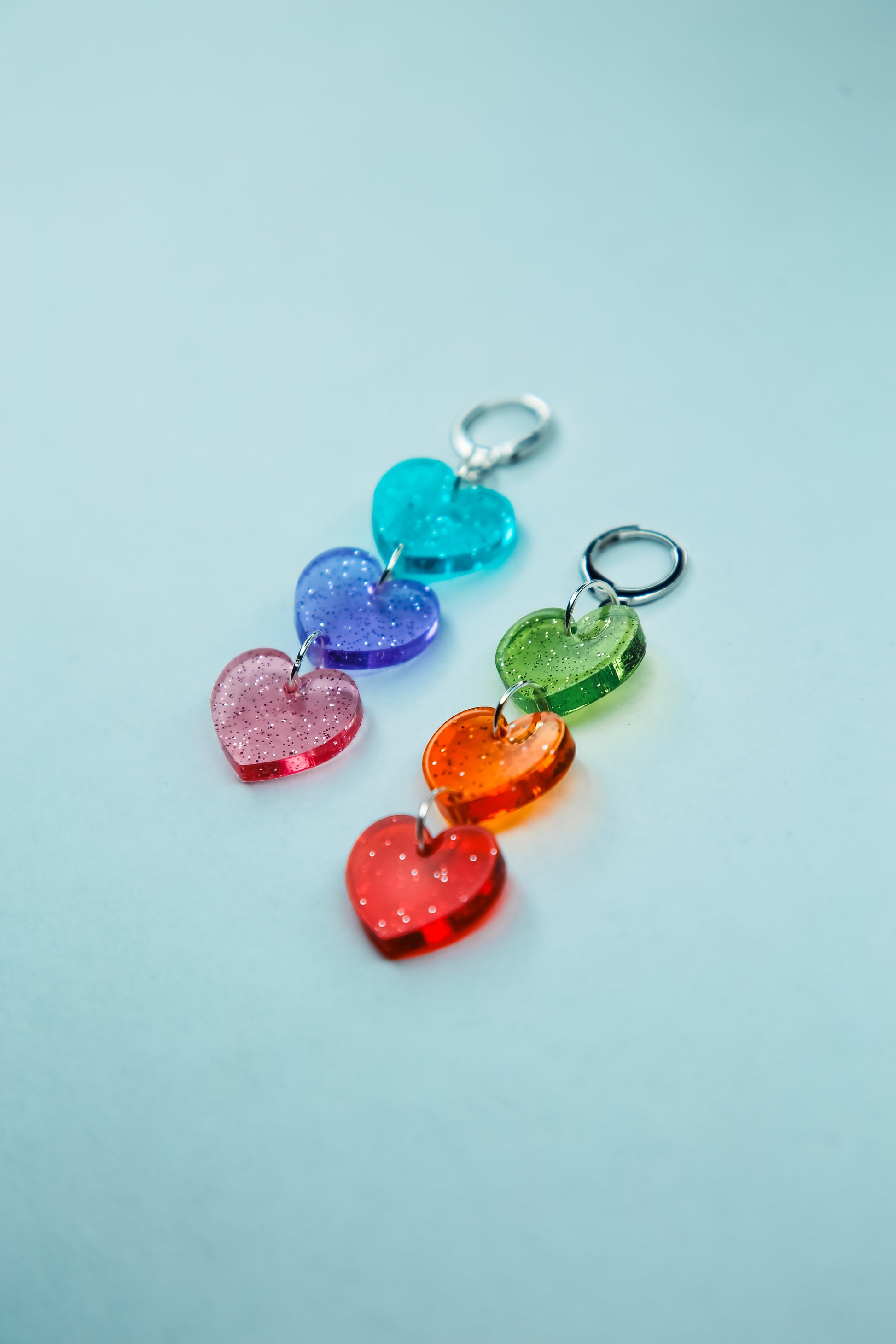 flat lay of multi coloured heart acrylic earrings