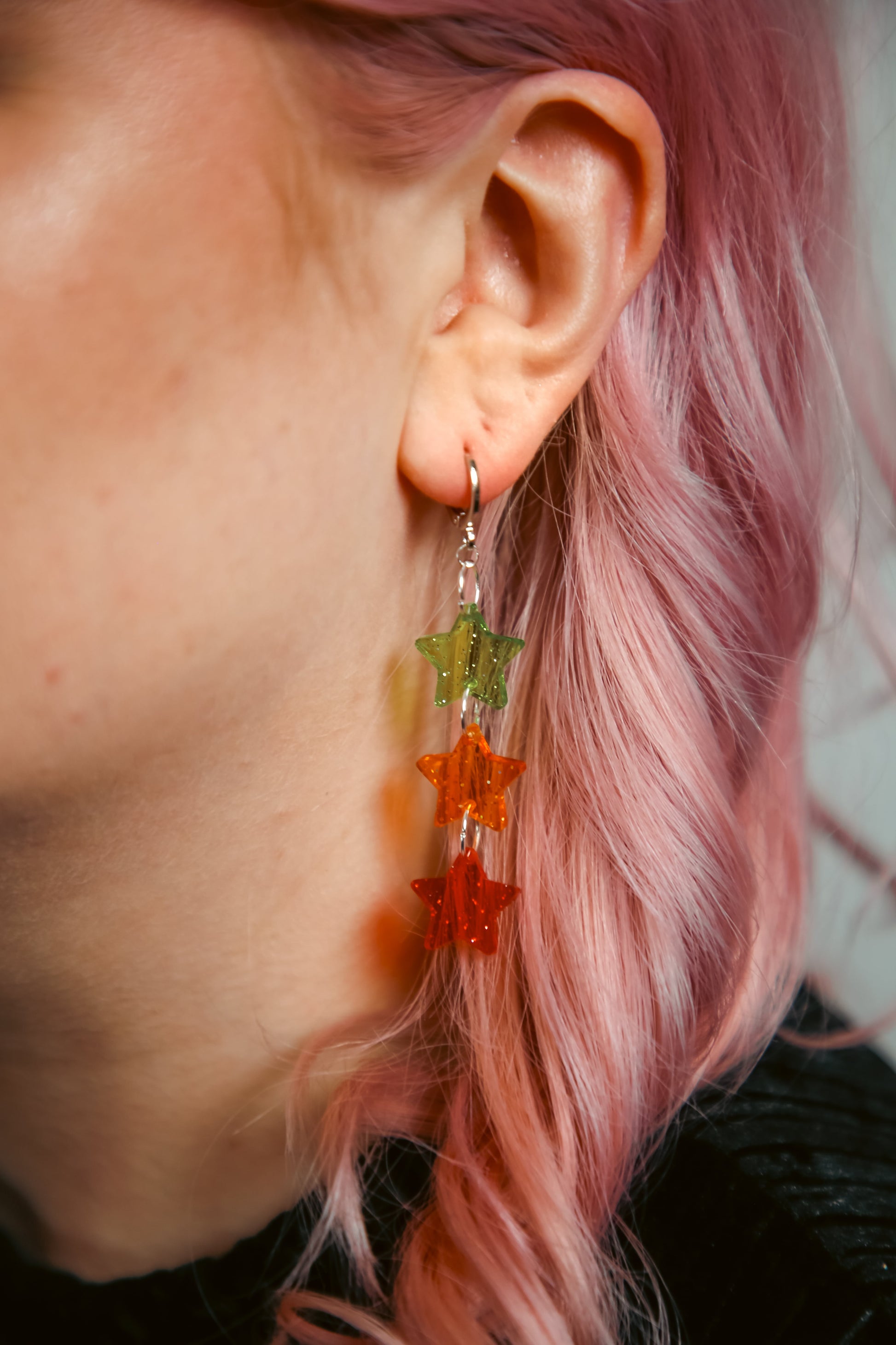 green, orange and red glittery transparent star acrylic earring