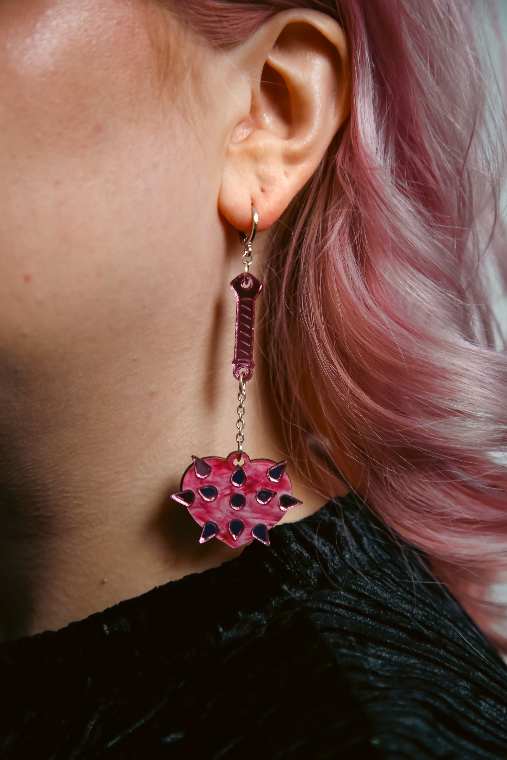 pink mace acrylic earring with pink heart shaped mace ball and reflective pink handle and spikes