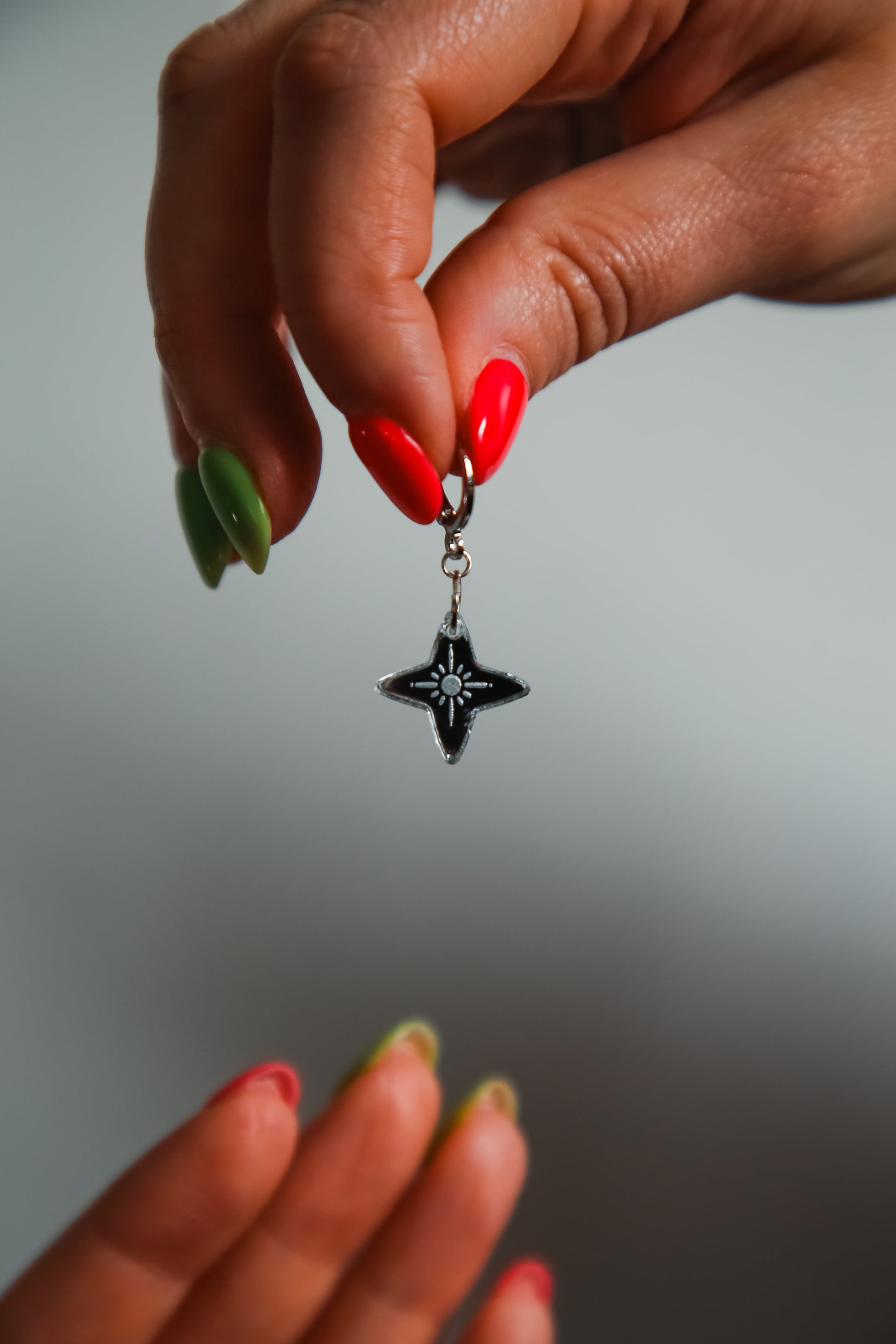 small silver star with reflective material being held by a hand